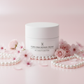 PDRN DNA Repair Cream white jar on light background with pink flowers